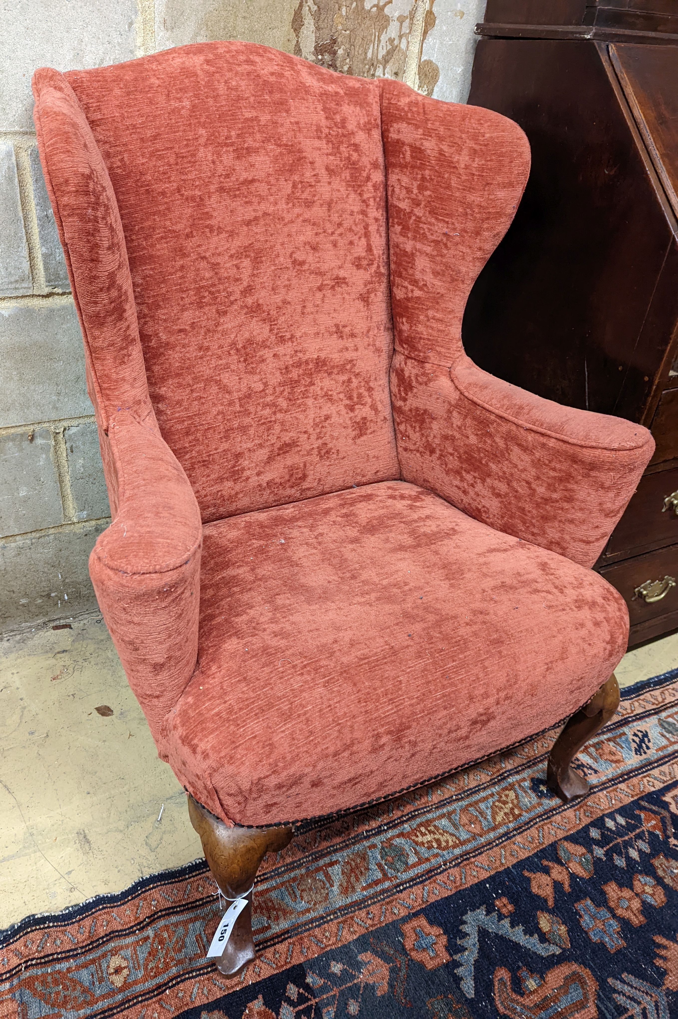 A Queen Anne style upholstered wingback armchair, width 78cm, depth 77cm, height 102cm